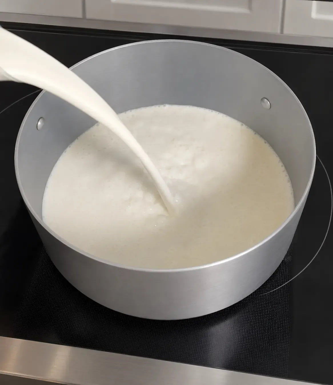 Milk poured into a pot for Ricotta