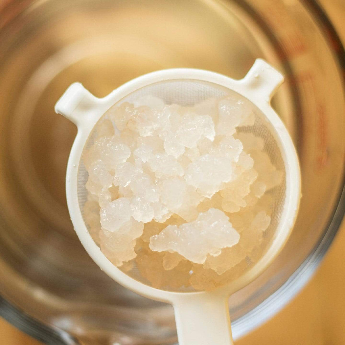 Kefir Water Kefir in a Strainer