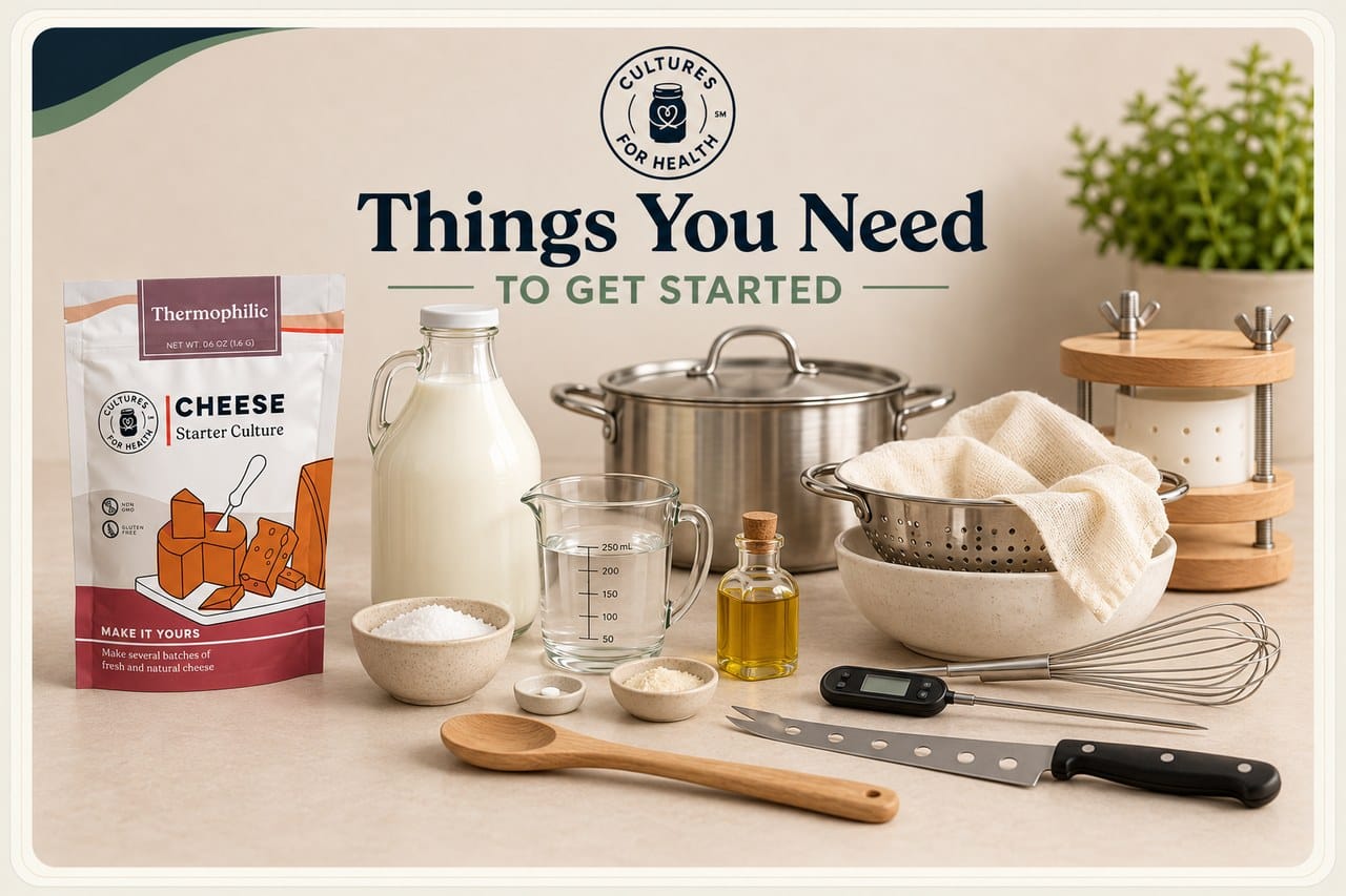 Starter, milk, cheesemaking tools and cheese press
