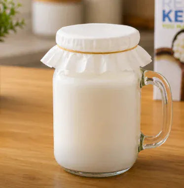 Jar covered with a coffee filter secured by a rubber band